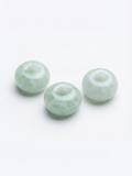 Pale green large-hole rondelle stone beads on a white background