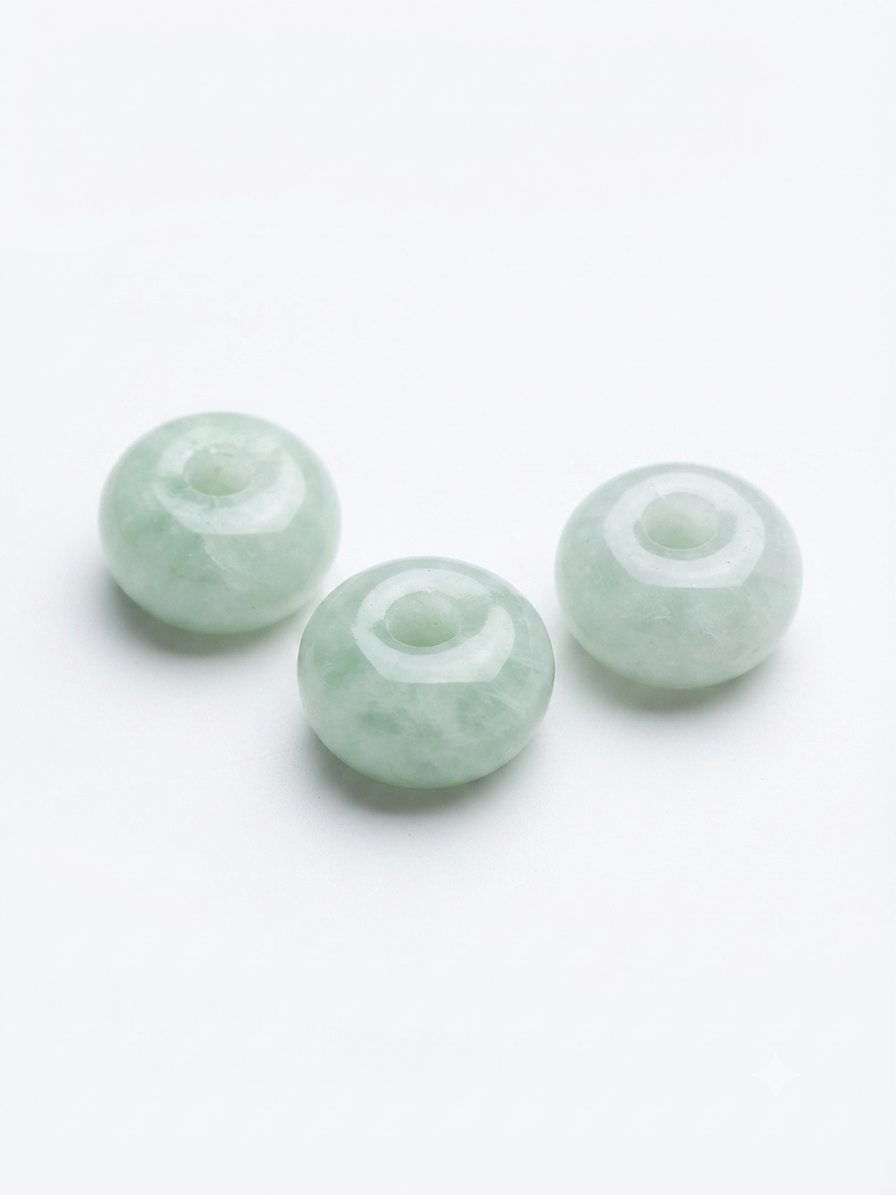 Pale green large-hole rondelle stone beads on a white background