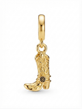 Gold-tone western cowboy boot charm on a white background