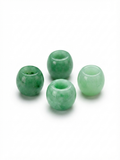 Green large-hole polished stone beads on a white background