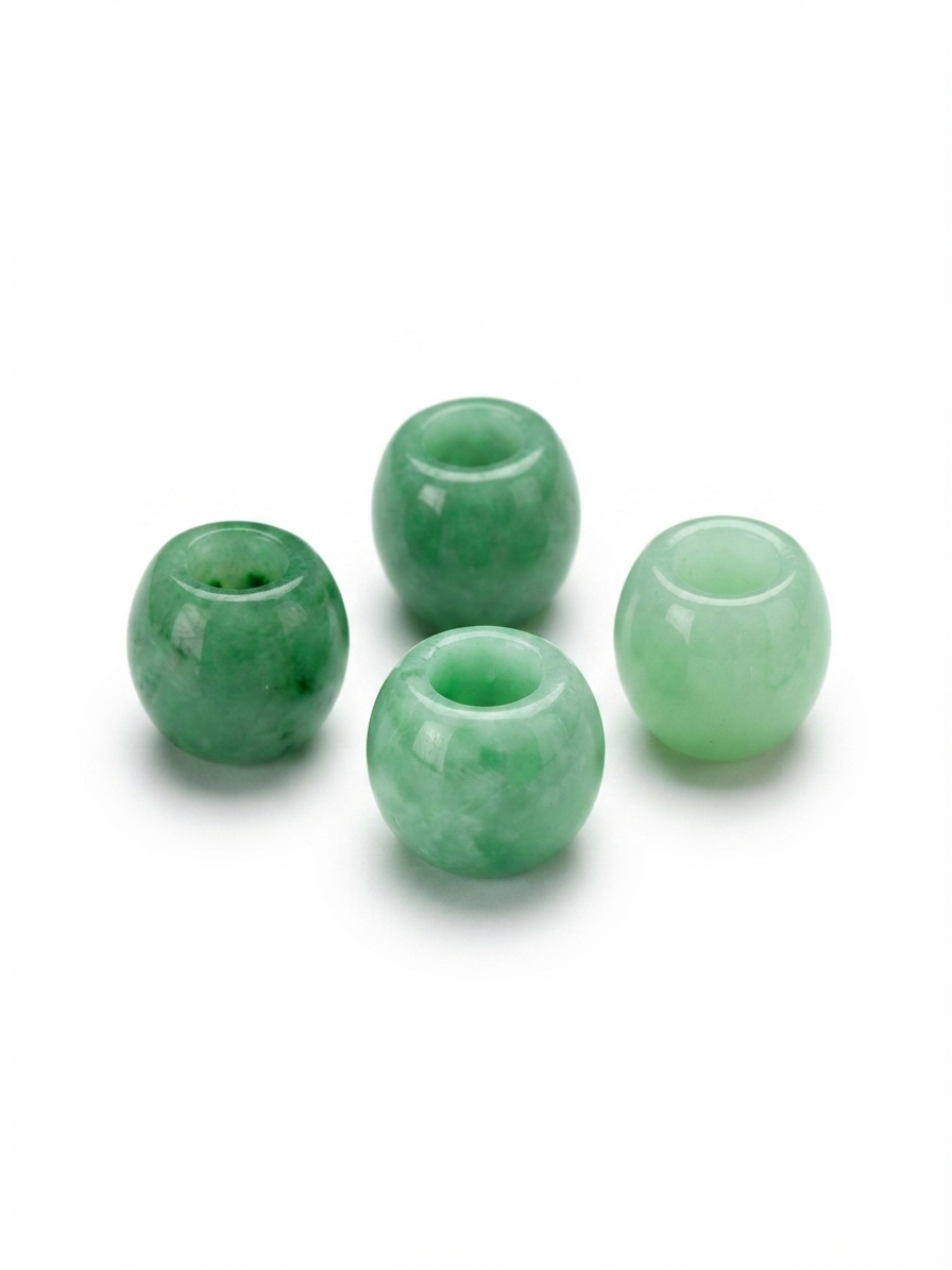 Green large-hole polished stone beads on a white background