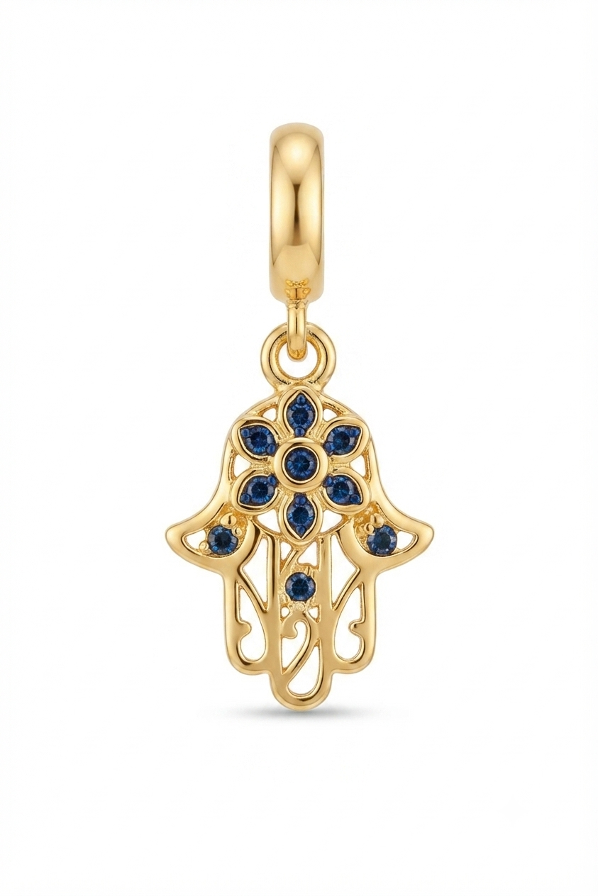Gold-tone Hamsa hand charm with blue crystals on a white background