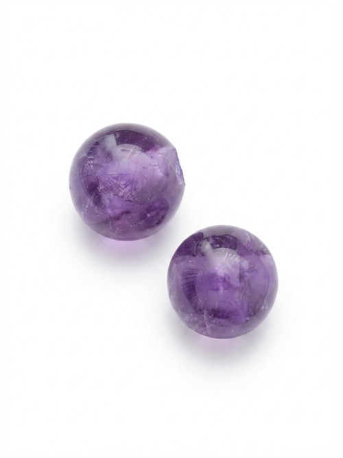 Purple amethyst round crystal beads on a white background