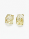 Faceted yellow crystal barrel beads on a white background