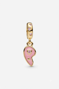 Gold-tone pink yin-yang charm with pink crystals on a white background