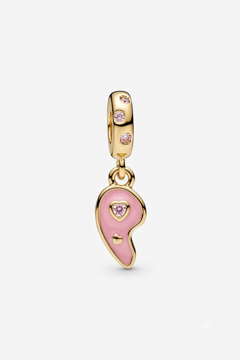 Gold-tone pink yin-yang charm with pink crystals on a white background