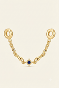 Gold-tone safety chain charm with a blue star crystal on a white background