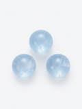 Pale blue aquamarine round crystal beads on a white background