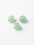 Light green translucent round crystal beads on a white background