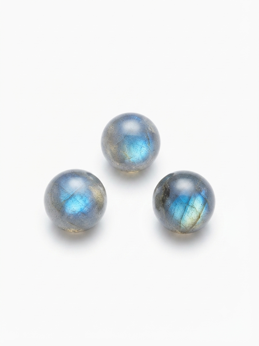 Labradorite round crystal beads with blue flash on a white background
